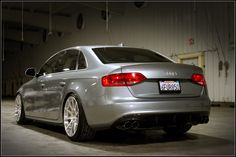 the rear end of a silver car parked in a garage