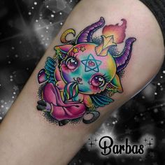 a colorful tattoo on the leg of a woman with an evil face and devil horns