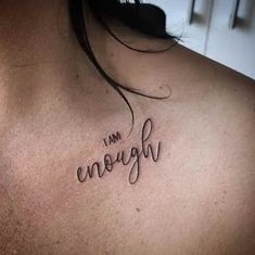 a woman's chest with the words i am enough tattooed on her left shoulder