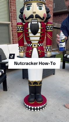 a large nutcracker statue sitting on top of a table next to a building