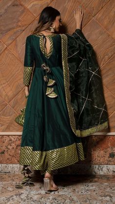 PRODUCT DESCRIPTION: Anarkali : Cotton silk Pant: Cotton silk Dupatta: Organza Color: Dark green work : Gotta lace work, allover anarkali ,pants and dupatta No. Of Components : Set of 3 Wash Care : Dry Clean Customization : Only Size and Length Of Product SKU#: 11403160GR Disclaimer: All our pieces are handcrafted in our manufacturing unit .We Ensure that our pieces are shot professionally under controlled lighting. Colours tend to be perceived differently depending on factors such as shot angle Dark Green Anarkali, अनारकली सूट, Green Anarkali, Silk Anarkali Suits, Silk Anarkali, Lehnga Dress, Lehenga Designs Simple, Punjabi Outfits, Latest Dress Design