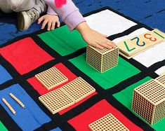 a child playing with wooden blocks and numbers