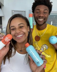 a man and woman holding up various items in front of their faces, including toothbrushes