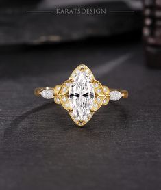 an oval cut diamond ring with three small diamonds on the band and side stones in yellow gold