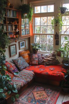 a living room filled with lots of plants next to a large window covered in potted plants