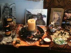 a table topped with pictures and candles on top of it