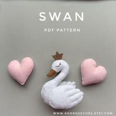 swans made out of felt sitting next to hearts