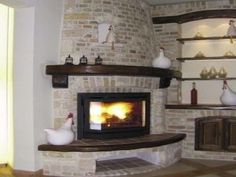 a living room with a fire place and shelves