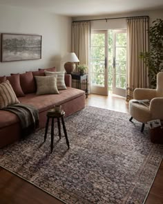 a living room filled with furniture and a large rug