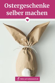 an easter bunny made out of brown paper and white cotton in front of the words, ostergeschemeke selber machen