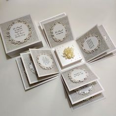 six cards with white and silver designs on them