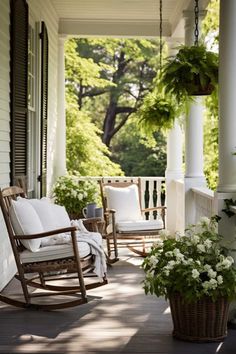 a porch with rocking chairs and potted plants