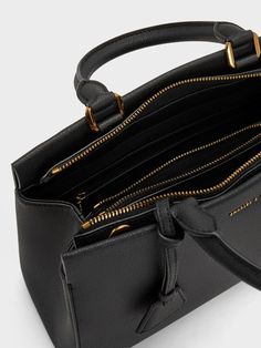 This product is made with at least 20% sustainable materials by weight. CHARLES & KEITH uses recycled, degradable, organic, and water-based materials in our eco-conscious collection. A polished carry-all is a wardrobe essential for the modern woman on the go, and the sleek Mirabelle structured top handle bag fits the bill. Its minimal black exterior exudes sophistication, complete with a gold-accent bag charm for visual interest. The secure zip closure opens up to a roomy interior that will fit everything you need and more. You can easily tote it by the sturdy top handles, or clip on the adjustable strap to sling it on the shoulder. Luxury Top Handle Shoulder Bag With Gunmetal Hardware, Black Purse Gold Hardware, Structured Bags For Women, Charles And Keith Bags, Dark Academia Outfit, Belt Ring, Structured Top, Structured Bag, Size Chart For Kids