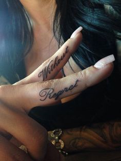 a woman with two fingers that have tattoos on them and the words without prayer written on it