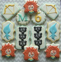 decorated cookies are arranged in the shape of animals and letters on top of each other