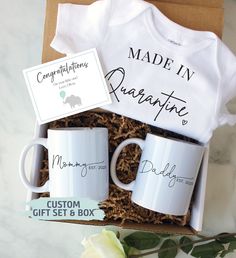 a baby gift box with two mugs and a t - shirt