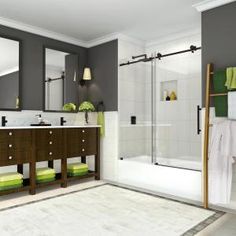 a bathroom with two sinks, a shower and green towels on the counter top in front of a mirror