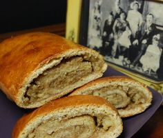 two pieces of bread on a purple plate with an old photo in the back ground