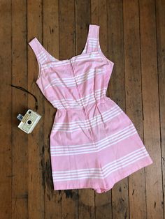 "*SHIPPING ANNOUNCEMENT* Away for the Holidays so enjoy a discount! Will ship sometime before the New Year but unsure exactly which day. Super cute pink cotton romper from the 1950s. This one has a metal zipper up the front and elastic at the waist for more movement.  Label: none Measurements: { xsmall - small } Bust: 34\"/35\"  Waist: 20\"-28\"  Hips: 37\" Length: 31\" Rise: 14.5\" Condition: excellent vintage condition with minor signs of wear - sold as found. washed and ready to wear  ☆Shop☆ http://www.trunkofdresses.com/" 1950s Shirtwaist Dress, Vintage Romper, Pink Romper, Womens Jumpsuits, Pink Rompers, Cotton Romper, Fashion Design Clothes, 50s Fashion, The 1950s