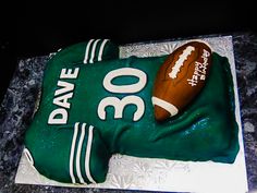 a football and glove cake on a table