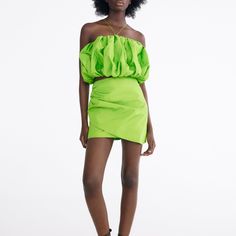 a woman in a short neon green dress