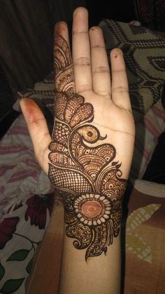 a woman's hand with henna tattoos on it