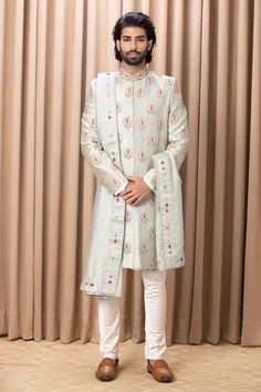 Mint green sherwani with zardozi embroidery in bouquet pattern and mandarin collared neckline. Paired with kurta, churidar and stole.
Component: 4
Pattern: Embroidery
Type Of Work: Zardozi, bouquet
Neckline: Mandarin collar
Sleeve Type: Full sleeves
Fabric: Raw Silk, Cotton Silk
Color: Green
Other Details: 
Front concealed button placket
Occasion: Groom - Aza Fashions Stole For Men, Mens Evening Wear, Green Sherwani, Raw Silk Embroidery, Embroidery Zardozi, Embroidered Sherwani, Formal Mens Fashion, Silk Kurta, Couture Outfits