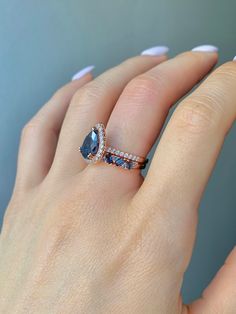 ✦Gorgeous London Blue Topaz Ring 2 Piece Set✦ ✧ Base Metal: 925 Sterling Silver ✧ Plating: 14K Rose Gold Vermeil ✧ Accented with Natural Crystals ✧ Average band width: 2.1 mm ✧ Center Stone: Topaz ✧ Color: London Blue ✧ Stone Cut: Pear ✧ Gem size: 8.0 x 6.0 mm ✧ Carat Weight: 1.21 ct. ✧ Gemstone creation: Natural ✧ Hardness: 8 (Mohs scale) ✧ Gemstone Origin: Switzerland ✧ Sizes 3.5-11.25 ✧ This ring set will arrive ready to gift in a Kherish Box. ✧ Due to the nature of the handmade process, each piece may slightly vary in color, size, shape, and contain natural inclusions. Every piece is gorgeous and one of a kind. *Please refer to photos for reference.  ✦ This Artist Has Autism✦ Every item you order from Kherish is handcrafted and packed by an artist with autism in RVA. Thanks to your sup Blue Topaz Engagement Ring, Topaz Engagement Ring, London Blue Topaz Ring, Topaz Color, Pear Engagement Ring, November Birthstone, Ring Promise, Anniversary Gift For Her, London Blue Topaz