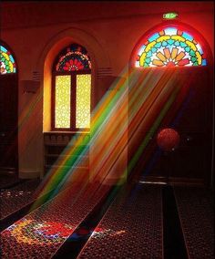 the sun shines brightly through stained glass windows