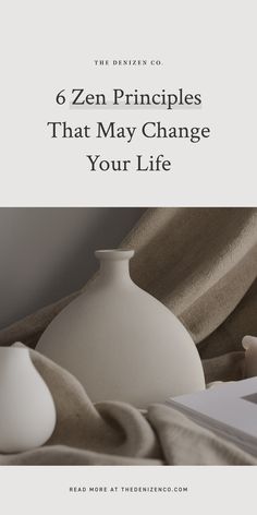 a white vase sitting on top of a bed