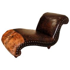 a brown leather chaise lounger with fur on it