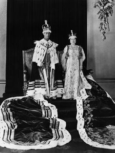 an old black and white photo of two women in regal dress standing next to each other