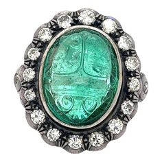 Antique Victorian Era 15 Carat Carved Emerald Beetle Ring With Diamond Halo Size 6.5 | Chairish Victorian Style Round Emerald Ring, Diamond Intaglio Jewelry, Round Diamond Intaglio Jewelry, Victorian Green Diamond Ring, Victorian Style Emerald Rings, Victorian Emerald Gemstone Ring, Victorian Emerald Collectible Ring, Beetle Ring, Carved Emerald