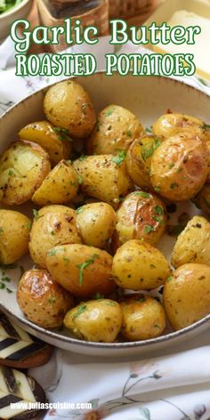 garlic butter roasted potatoes in a white bowl on a floral tablecloth with text overlay