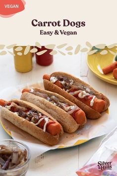 two hot dogs on buns with ketchup and mayonnaise sitting on a plate