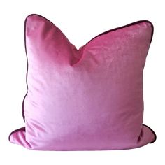 a pink pillow on a white background