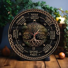 a wooden table topped with a tree of life clock