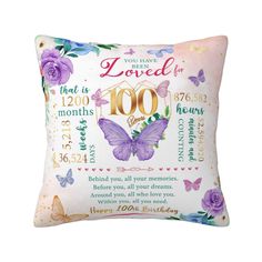 a pillow with the words loved for 100 years on it and purple butterflies around it