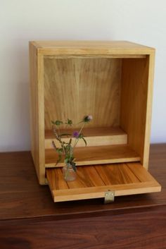 a small wooden box with flowers in it