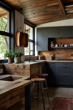 a kitchen with lots of wooden cabinets and stools next to an open floor plan