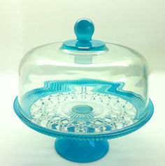 a glass cake dish with a blue base