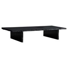 a black table sitting on top of a white wall