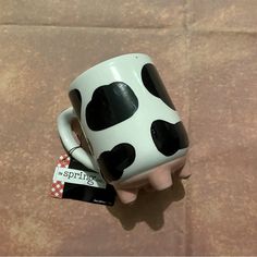 a coffee mug with black and white polka dots on it