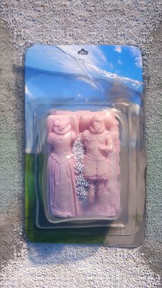 two pink plastic figurines are in the package