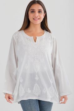 Our Saheli Embroidered Tunic is hand embroidered by women artisans in Uttar Pradesh, India. The embroidery motifs are first block-printed onto the garment and then the women do the embroidery in their homes, which allows them to do the work on their own schedule between other household work. Our soft embroidered cotton tunic tops feature fine embroidery on the front and back and are designed for a comfortable, elegant fit. Available in two sizes, S/M and L/XL. Traditional Long Sleeve Tops With Tonal Embroidery, Festive Traditional Tops With Tonal Embroidery, Bohemian Chikankari Embroidered Fabric, Festive Cotton Tops With Embroidered Border, Festive Folk Embroidered Top, Long Sleeve Blouse With Motif, White Cotton Blouse With Tonal Embroidery, Traditional Cotton Blouse With Tonal Embroidery, Traditional Cotton Tops With Tonal Embroidery