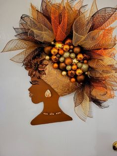 a woman's head is adorned with orange and gold decorations