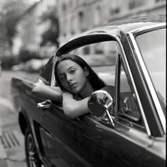 a woman leaning out the window of a car