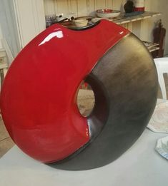 a large red sculpture sitting on top of a white table