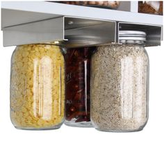 an open refrigerator door with various jars and food items in the bottom shelf, including corn