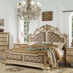 a bed room with a neatly made bed and a chandelier